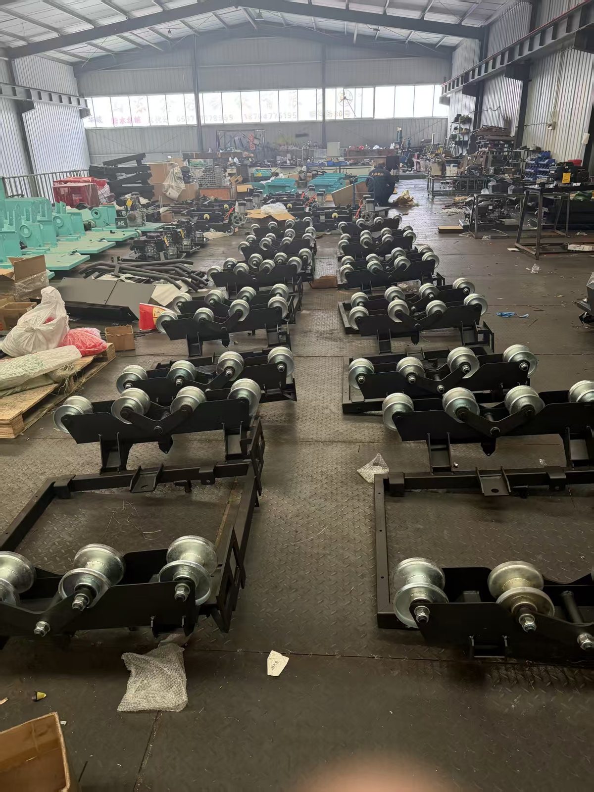 TorqMax factory workshop — machine components staged for production