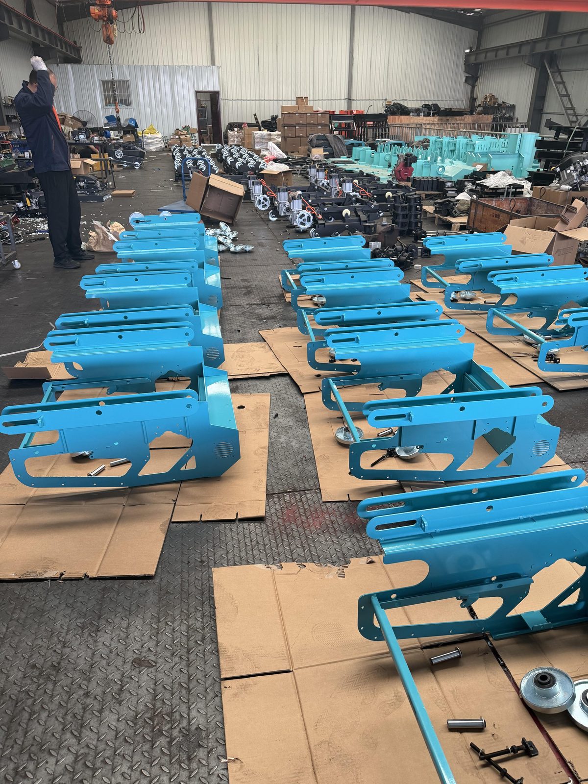 TorqMax factory interior — finished remote-controlled mowers ready for testing